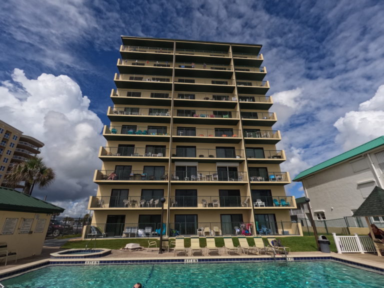 a photo of the pool and high rise building of Sunglow Resort Condotele